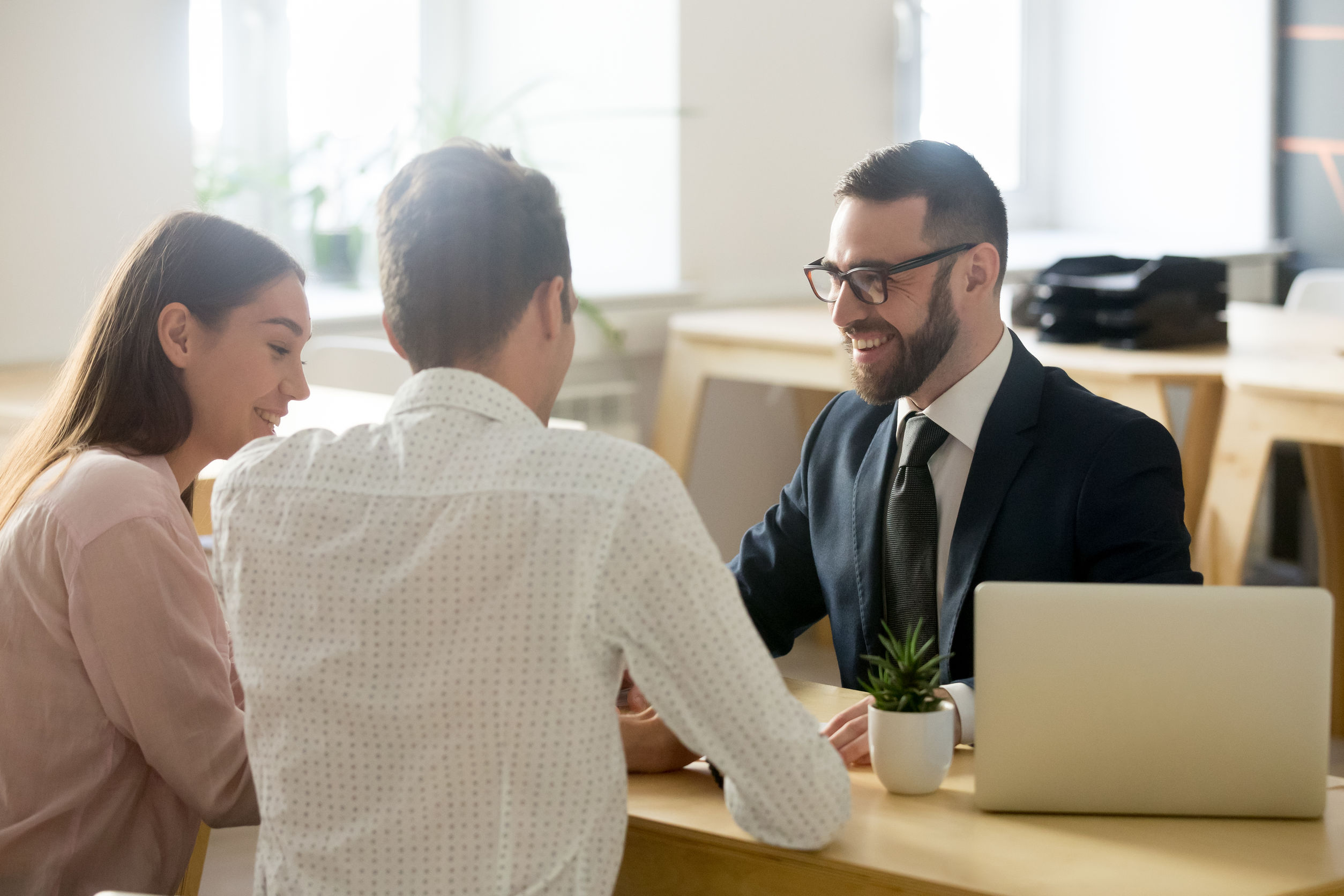 friendly lawyer or financial advisor in suit consulting young co